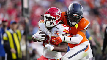 Nov 16, 2025; Denver, Colorado, USA; Denver Broncos linebacker Nik Bonitto (15) tackles Kansas City Chiefs running back Kareem Hunt (29) carries the ball in the third quarter at Empower Field at Mile High. Mandatory Credit: Ron Chenoy-Imagn Images