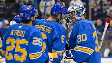 Mar 22, 2025; St. Louis, Missouri, USA;  St. Louis Blues goaltender Joel Hofer (30) and defenseman Philip Broberg (6) celebrate after the Blues defeated the Chicago Blackhawks at Enterprise Center. Mandatory Credit: Jeff Curry-Imagn Images