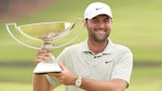Sep 1, 2024; Atlanta, Georgia, USA; Scottie Scheffler celebrates winning the TOUR Championship golf tournament. Mandatory Credit: John David Mercer-Imagn Images