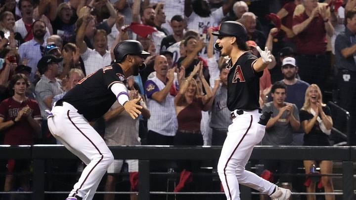 Arizona Diamondbacks center fielder Alek Thomas (right) celebrates with left fielder Lourdes Gurriel