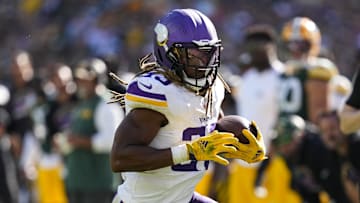 Sep 29, 2024; Green Bay, Wisconsin, USA;  Minnesota Vikings running back Aaron Jones (33) rushes with the football during the fourth quarter against the Green Bay Packers at Lambeau Field.