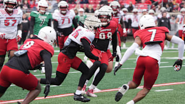 Louisville Duke Watson (26) catches the ball and ran from some yardage against Red Louisville Rodney Johnson (7) in the Spring Game Friday night at L & N Stadium.
April 11, 2025