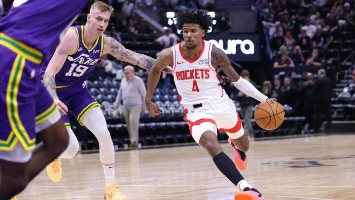 Apr 11, 2024; Salt Lake City, Utah, USA; Houston Rockets guard Jalen Green (4) dribbles past Utah Jazz forward Luka Samanic (19) during the third quarter at Delta Center. Mandatory Credit: Rob Gray-USA TODAY Sports