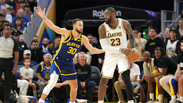Jan 27, 2024; San Francisco, California, USA; Los Angeles Lakers forward LeBron James (23) handles the ball against Golden State Warriors guard Stephen Curry (30) during overtime at Chase Center. Mandatory Credit: Darren Yamashita-Imagn Images