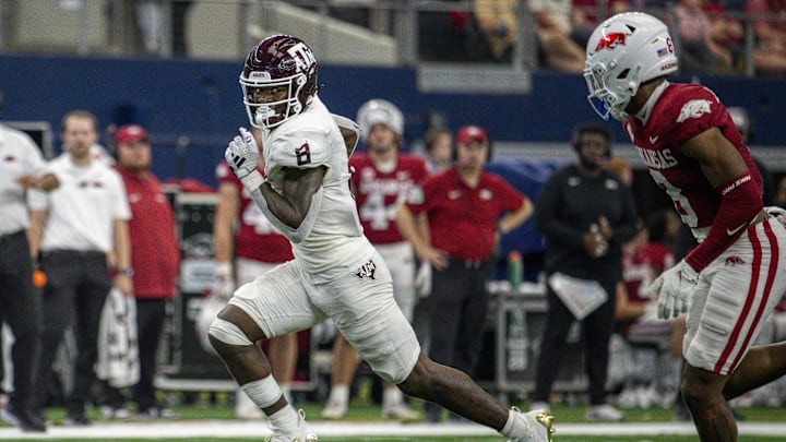 Sep 30, 2023; Arlington, Texas, USA; Texas A&M Aggies running back Le'Veon Moss (8) and Arkansas Razorbacks defensive back Jayden Johnson (8) In action during the game between the Texas A&M Aggies and the Arkansas Razorbacks at AT&T Stadium. Mandatory Credit: Jerome Miron-Imagn Images