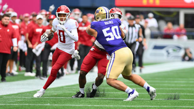 WSU's Tony Freeman returns a punt 33 yards in the Apple Cup while Sebastian Valdez gives chase. 