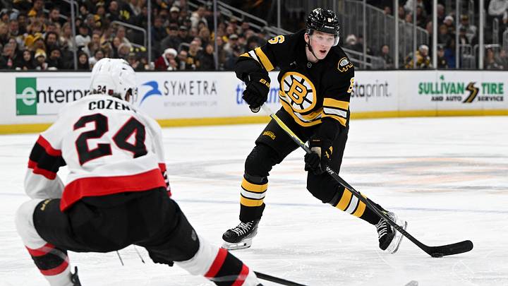 Dec 21, 2025; Boston, Massachusetts, USA; Boston Bruins defenseman Mason Lohrei #6 passes the puck against Ottawa Senators center Dylan Cozens #24 during the third period at the TD Garden. Mandatory Credit: Brian Fluharty-Imagn Images Dec 21, 2025; Boston, Massachusetts, USA; Boston Bruins defenseman Mason Lohrei #6 passes the puck against Ottawa Senators center Dylan Cozens #24 during the third period at the TD Garden. Mandatory Credit: Brian Fluharty-Imagn Images