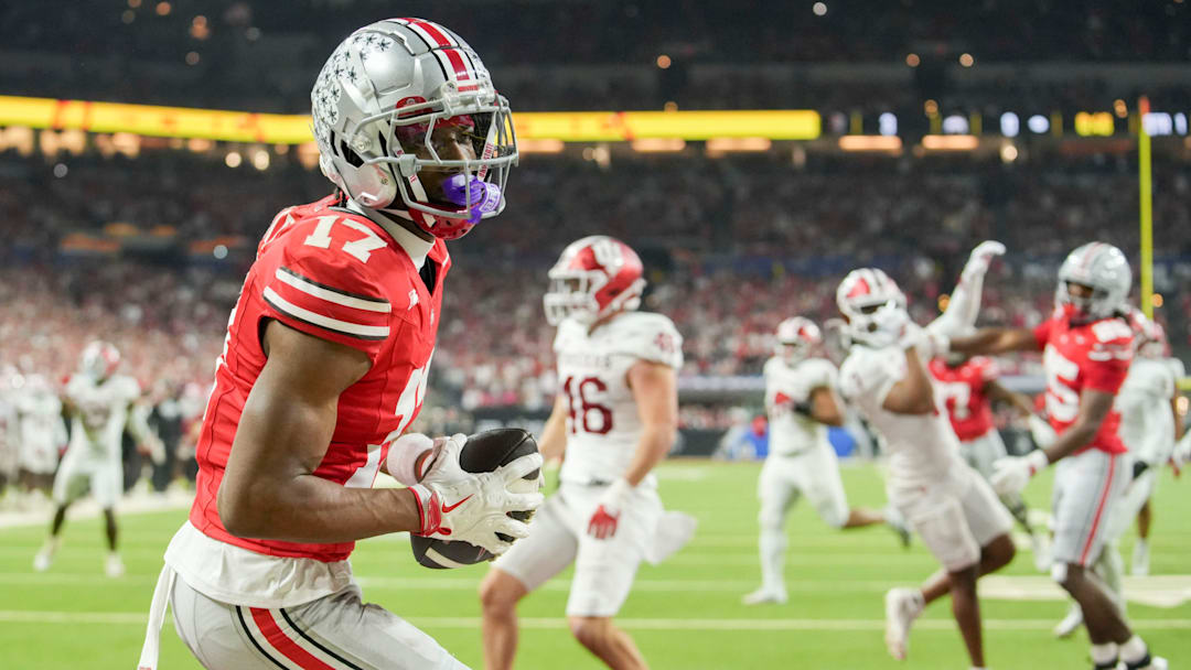 Ohio State Buckeyes wide receiver Carnell Tate (17) makes a catch for a touchdown Saturday, Dec. 6, 2025, during the Big Ten football championship against the Indiana Hoosiers at Lucas Oil Stadium in Indianapolis.