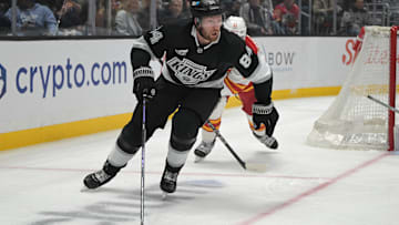 Apr 17, 2025; Los Angeles, California, USA;  Los Angeles Kings defenseman Vladislav Gavrikov (84) controls the puck during the second period at Crypto.com Arena. Mandatory Credit: Jayne Kamin-Oncea-Imagn Images
