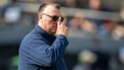 Oct 4, 2025; West Lafayette, Indiana, USA; Illinois Fighting Illini head coach Bret Bielema watches warm ups before the game against the Purdue Boilermakers at Ross-Ade Stadium. Mandatory Credit: Marc Lebryk-Imagn Images