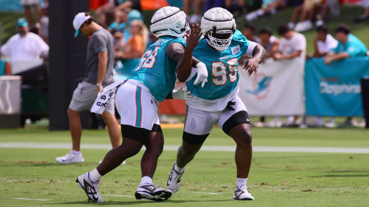 Jul 28, 2024; Miami Gardens, FL, USA; Miami Dolphins defensive tackle Benito Jones (95) and defensive tackle Mario Kendricks (68) work out during training camp at Baptist Health Training Complex.