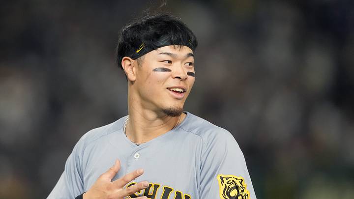 Mar 15, 2025; Bunkyo, Tokyo, Japan; Hanshin Tigers right fielder Teruaki Sato (8) during the fifth inning against the Chicago Cubs at Tokyo Dome. Mandatory Credit: Darren Yamashita-Imagn Images