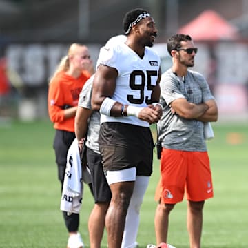 Jul 26, 2025; Berea, OH, USA; Cleveland Browns defensive end Myles Garrett (95) talks to quarterback Shedeur Sanders (12) during training camp at CrossCountry Mortgage Campus. Mandatory Credit: Ken Blaze-Imagn Images