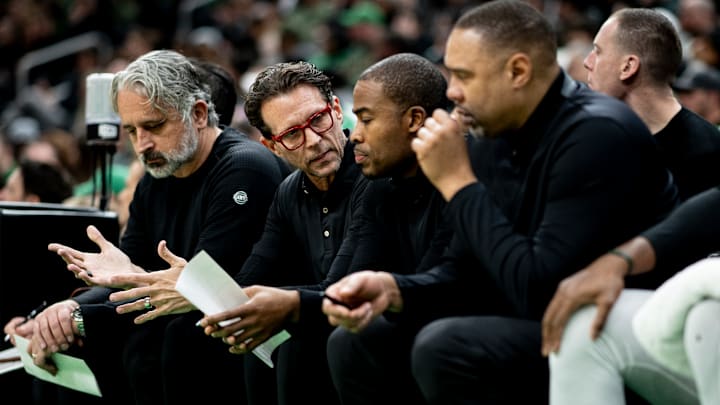 Atlanta Hawks head coach Quin Snyder speaks with his staff during a game against the Boston Celtics.