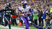 Dec 22, 2024; Seattle, Washington, USA; Minnesota Vikings wide receiver Justin Jefferson (18) catches a touchdown pass against Seattle Seahawks safety Julian Love (20) during the fourth quarter at Lumen Field.