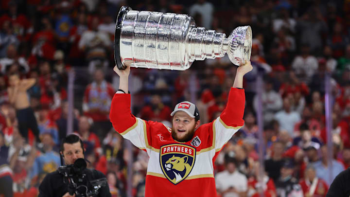 Jun 24, 2024; Sunrise, Florida, USA; Florida Panthers center Steven Lorentz (18) lifts with the cup after winning game seven of the 2024 Stanley Cup Final against the Edmonton Oilers at Amerant Bank Arena. Mandatory Credit: Sam Navarro-USA TODAY Sports