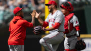 Jul 24, 2024; Seattle, Washington, USA;  Los Angeles Angels designated hitter Willie Calhoun (5), left, relief pitcher Carlos Estevez (53), center, and catcher Matt Thaiss (21) celebrate after a game Mariners at T-Mobile Park. Mandatory Credit: Stephen Brashear-USA TODAY Sports