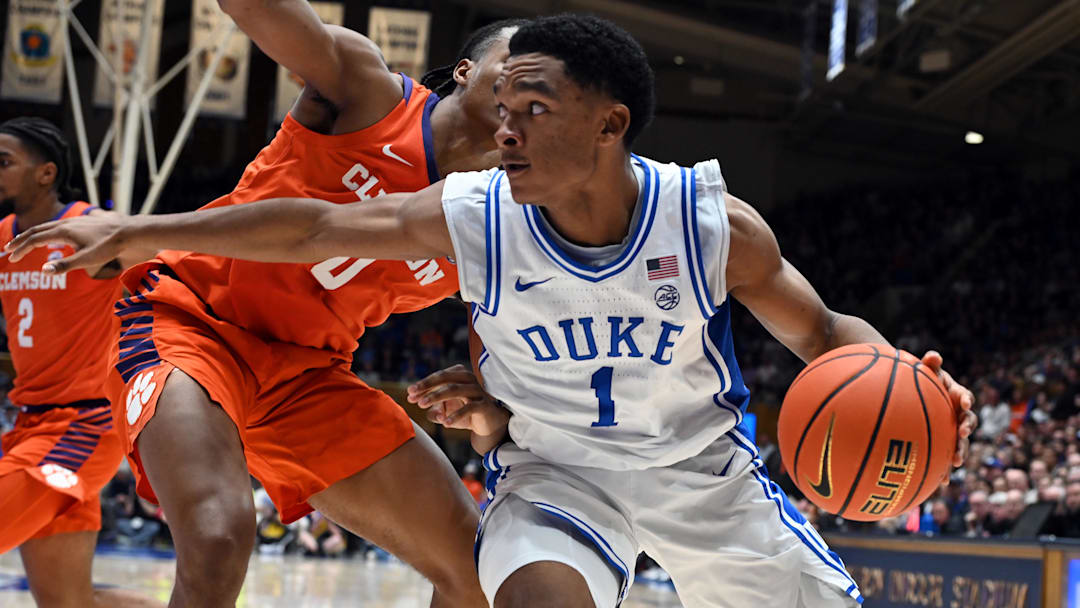 Feb 14, 2026; Durham, North Carolina, USA; Duke Blue Devils guard Caleb Foster (1) controls the ball in front of Clemson Tigers forward RJ Godfrey (0) during the second half at Cameron Indoor Stadium. Mandatory Credit: Rob Kinnan-Imagn Images