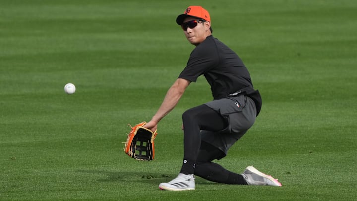 Feb 13, 2025; Scottsdale, AZ, USA; San Francisco Giants outfielder Jung Hoo Lee (51) catches fly balls during spring training camp. Feb 13, 2025; Scottsdale, AZ, USA; San Francisco Giants outfielder Jung Hoo Lee (51) catches fly balls during spring training camp.