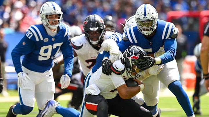 Sep 8, 2024; Indianapolis, Indiana, USA; Houston Texans quarterback C.J. Stroud (7) is sacked by Indianapolis Colts defensive end Dayo Odeyingbo (54) during the second half at Lucas Oil Stadium. Mandatory Credit: Marc Lebryk-Imagn Images