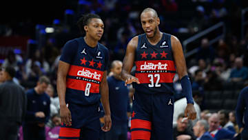 Mar 5, 2025; Washington, District of Columbia, USA; Washington Wizards forward Khris Middleton (32) and guard Bub Carrington (8) talk during the third quarter against the Utah Jazz at Capital One Arena. Mandatory Credit: Reggie Hildred-Imagn Images
