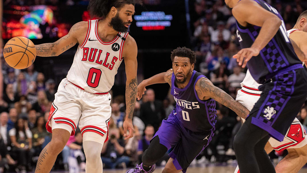 Mar 20, 2025; Sacramento, California, USA; Chicago Bulls guard Coby White (0) controls the ball against Sacramento Kings guard Malik Monk (0) and forward Keegan Murray (13) during the fourth quarter at Golden 1 Center. Mandatory Credit: Ed Szczepanski-Imagn Images