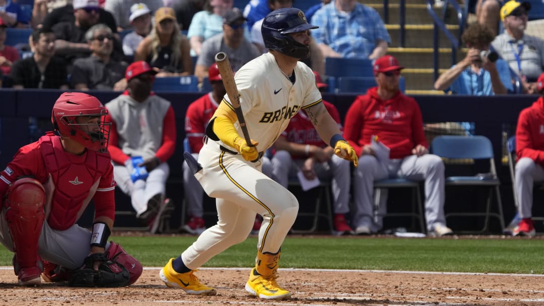 Mar 18, 2024; Phoenix, Arizona, USA; Milwaukee Brewers center fielder Garrett Mitchell (5) hits a single against the Los Angeles Angels in the second inning at American Family Fields of Phoenix. Mandatory Credit: Rick Scuteri-USA TODAY Sports