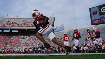 Sep 20, 2025; Madison, Wisconsin, USA;  Wisconsin Badgers running back Dilin Jones (7) carries the football during warmups prior to the game against the Maryland Terrapins at Camp Randall Stadium.