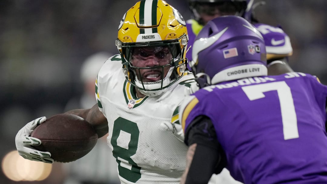 Green Bay Packers running back Josh Jacobs (8) looks for running room during their game at the Minnesota Vikings.