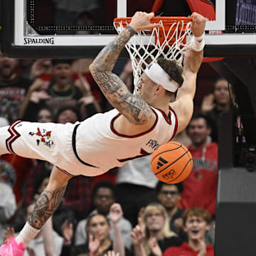 Nov 6, 2025; Louisville, Kentucky, USA;  Louisville Cardinals forward Kasean Pryor (7) dunks against Jackson State Tigers forward Jayme Mitchell Jr. (3) during the first half at KFC Yum! Center. Mandatory Credit: Jamie Rhodes-Imagn Images