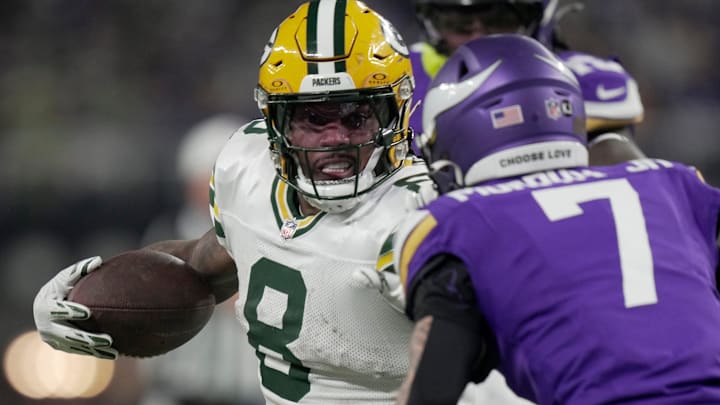 Green Bay Packers running back Josh Jacobs (8) looks for running room during their game at the Minnesota Vikings. Green Bay Packers running back Josh Jacobs (8) looks for running room during their game at the Minnesota Vikings.