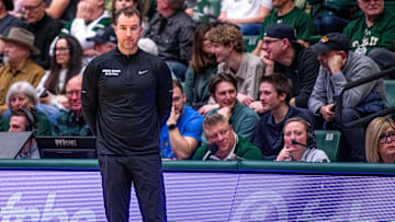Utah State basketball head coach Danny Sprinkle stares off into the distance after a turnover in a blowout loss against Colorado State at Moby Arena on Saturday, Feb. 17, 2024 in Fort Collins, Colo.