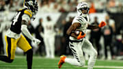 Cincinnati Bengals wide receiver Ja'Marr Chase (1) runs downfield as Pittsburgh Steelers cornerback Joey Porter Jr. (24) goes to tackle him in the third quarter of the NFL game between the Cincinnati Bengals and Pittsburgh Steelers at Paycor Stadium in Cincinnati on Oct. 16, 2025.