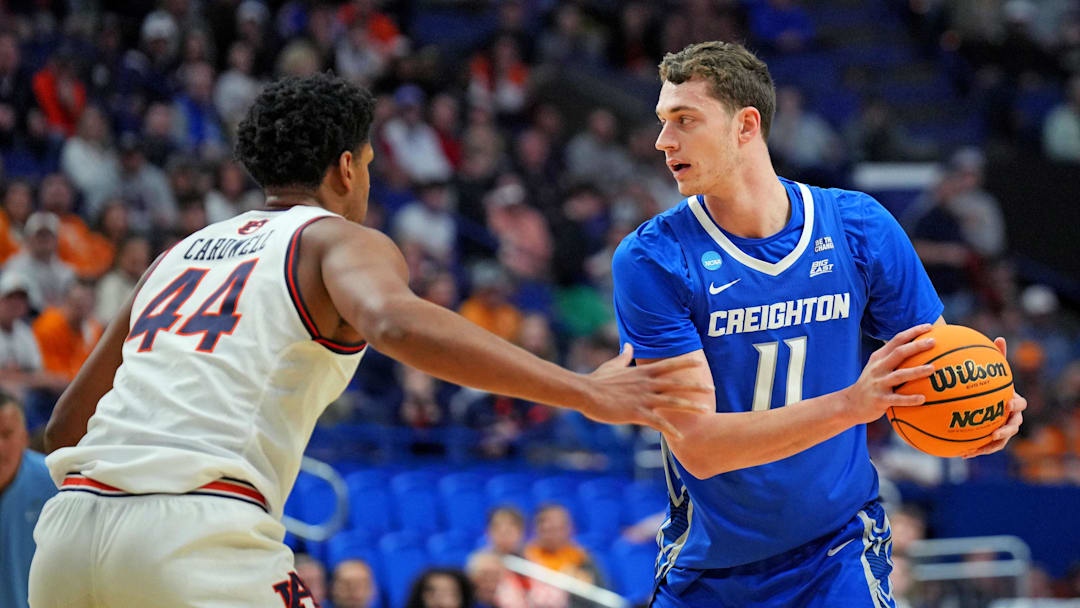 Mar 22, 2025; Lexington, KY, USA;  Creighton Bluejays center Ryan Kalkbrenner (11) handles the ball against Auburn Tigers center Dylan Cardwell (44) during the first half in the second round to the NCAA Tournament at Rupp Arena. Mandatory Credit: Aaron Doster-Imagn Images