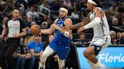 Mar 27, 2025; Orlando, Florida, USA; Dallas Mavericks guard-forward Klay Thompson (31) dribbles the ball against Orlando Magic forward Paolo Banchero (5) in the first quarter at Kia Center. Mandatory Credit: Jeremy Reper-Imagn Images