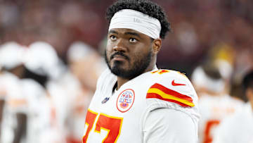 Aug 9, 2025; Glendale, Arizona, USA; Kansas City Chiefs guard Jaylon Moore (77) against the Arizona Cardinals during a preseason NFL game at State Farm Stadium.