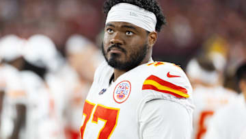 Aug 9, 2025; Glendale, Arizona, USA; Kansas City Chiefs guard Jaylon Moore (77) against the Arizona Cardinals during a preseason NFL game at State Farm Stadium.