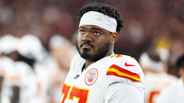 Aug 9, 2025; Glendale, Arizona, USA; Kansas City Chiefs guard Jaylon Moore (77) against the Arizona Cardinals during a preseason NFL game at State Farm Stadium.