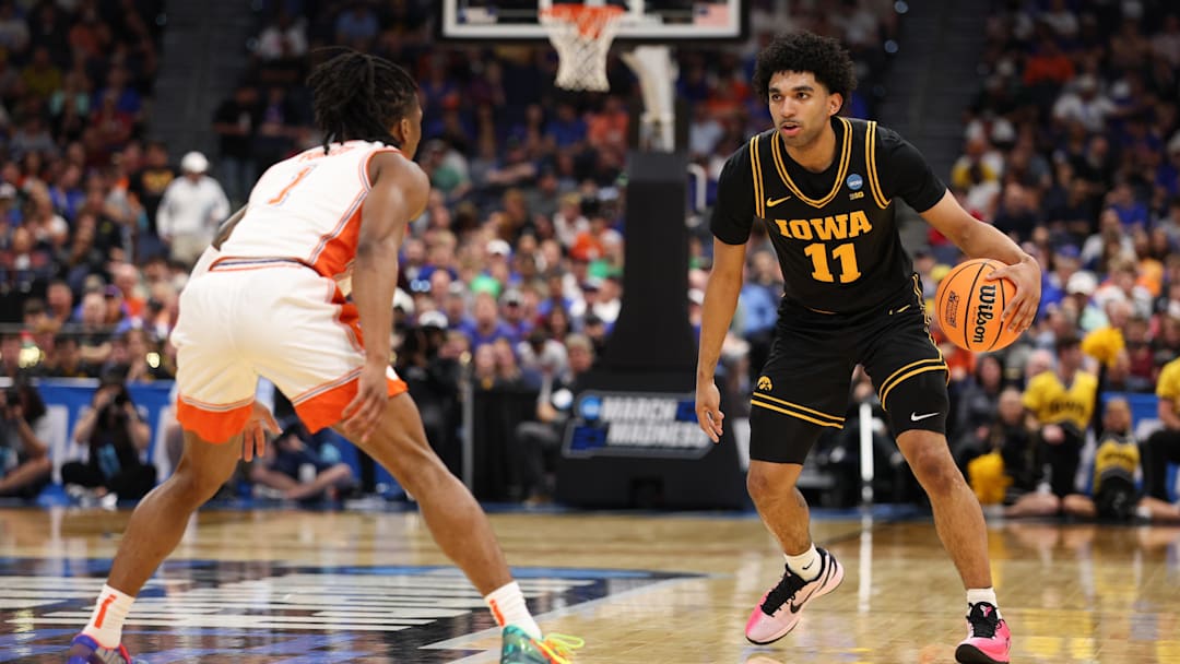 Mar 20, 2026; Tampa, FL, USA; Iowa Hawkeyes guard Kael Combs (11) moves the ball while defended by Clemson Tigers guard Jestin Porter (1) in the first half during a first round game of the men's 2026 NCAA Tournament at Benchmark International Arena. Mandatory Credit: Nathan Ray Seebeck-Imagn Images Mar 20, 2026; Tampa, FL, USA; Iowa Hawkeyes guard Kael Combs (11) moves the ball while defended by Clemson Tigers guard Jestin Porter (1) in the first half during a first round game of the men's 2026 NCAA Tournament at Benchmark International Arena. Mandatory Credit: Nathan Ray Seebeck-Imagn Images