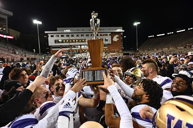 The Huskies hold the Apple Cup trophy after the 2022 game.