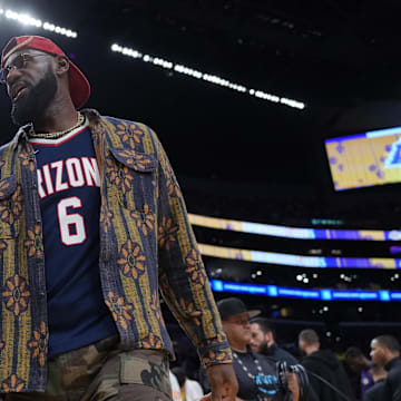 Oct 24, 2025; Los Angeles, California, USA; Los Angeles Lakers forward LeBron James poses in the Arizona Wildcats jersey of his son Bryce James (6) during the game against the Minnesota Timberwolves at Crypto.com Arena. Mandatory Credit: Kirby Lee-Imagn Images