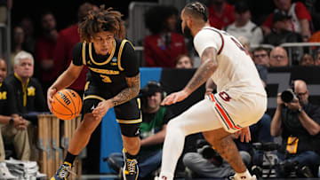 Mar 28, 2025; Atlanta, GA, USA; Michigan Wolverines guard Tre Donaldson (3) drives against Auburn Tigers forward Johni Broome (4) in the second half of a South Regional semifinal of the 2025 NCAA tournament at State Farm Arena. Mandatory Credit: Dale Zanine-Imagn Images