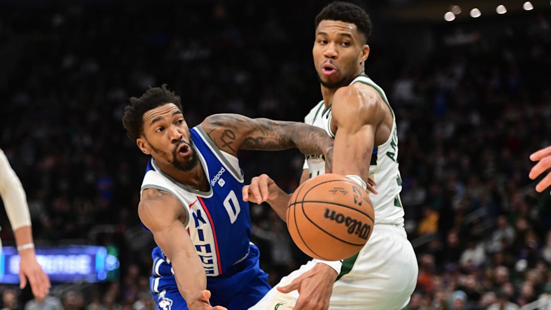 Jan 14, 2024; Milwaukee, Wisconsin, USA; Sacramento Kings guard Malik Monk (0) passes the ball away from Milwaukee Bucks forward Giannis Antetokounmpo (34) in overtime at Fiserv Forum.