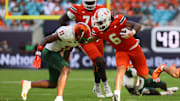 Sep 7, 2024; Miami Gardens, Florida, USA; Miami Hurricanes running back Damien Martinez (6) runs with the football against Florida A&M Rattlers defensive back Deco Wilson (11) at Hard Rock Stadium. Mandatory Credit: Sam Navarro-Imagn Images