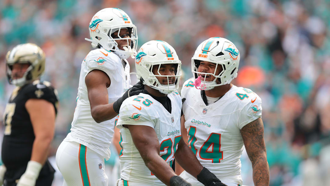 Nov 30, 2025; Miami Gardens, Florida, USA; Miami Dolphins linebacker Tyrel Dodson (25) celebrates with teammates linebacker K.J. Britt (3) and linebacker Chop Robinson (44) after breaking up a pass against the New Orleans Saints during the first half at Hard Rock Stadium. Mandatory Credit: Sam Navarro-Imagn Images Nov 30, 2025; Miami Gardens, Florida, USA; Miami Dolphins linebacker Tyrel Dodson (25) celebrates with teammates linebacker K.J. Britt (3) and linebacker Chop Robinson (44) after breaking up a pass against the New Orleans Saints during the first half at Hard Rock Stadium. Mandatory Credit: Sam Navarro-Imagn Images