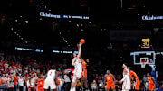 Oklahoma Sooners forward Sam Godwin (10) and Oklahoma State Cowboys forward Robert Jennings II (25) jump for the ball during the opening tip during a men's college Bedlam basketball game between the University of Oklahoma Sooners (OU) and the Oklahoma State University Cowboys (OSU) at Paycom Center in Oklahoma City, Saturday, Dec. 14, 2024. Oklahoma won 80-65.