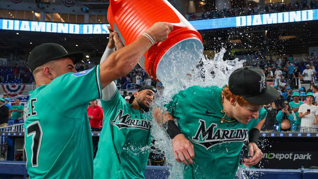 Mar 29, 2026; Miami, Florida, USA; Miami Marlins right fielder Owen Caissie (17) is doused with water by center fielder Jakob Marsee (87) and catcher Agustin Ramirez (50) after hitting a two-run walk-off home run against the Colorado Rockies during the ninth inning at loanDepot Park. Mandatory Credit: Sam Navarro-Imagn Images
