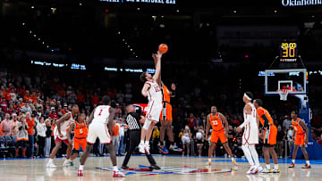 Oklahoma Sooners forward Sam Godwin (10) and Oklahoma State Cowboys forward Robert Jennings II (25) jump for the ball during the opening tip during a men's college Bedlam basketball game between the University of Oklahoma Sooners (OU) and the Oklahoma State University Cowboys (OSU) at Paycom Center in Oklahoma City, Saturday, Dec. 14, 2024. Oklahoma won 80-65.