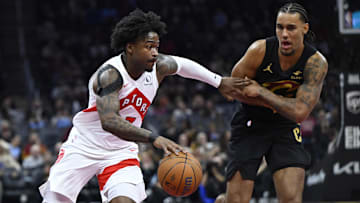 Oct 31, 2025; Cleveland, Ohio, USA; Toronto Raptors guard Jamal Shead (23) dribbles beside Cleveland Cavaliers forward Jaylon Tyson (20) in the third quarter at Rocket Arena. Mandatory Credit: David Richard-Imagn Images
