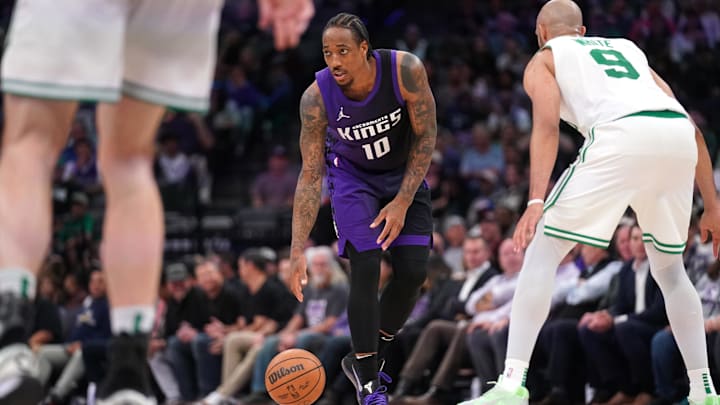 Mar 24, 2025; Sacramento, California, USA; Sacramento Kings guard DeMar DeRozan (10) dribbles the ball next to Boston Celtics guard Derrick White (9) in the fourth quarter at the Golden 1 Center. Mandatory Credit: Cary Edmondson-Imagn Images